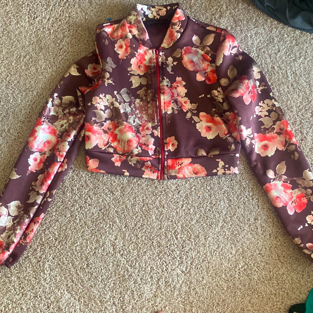 Small cropped maroon jacket with floral pattern.